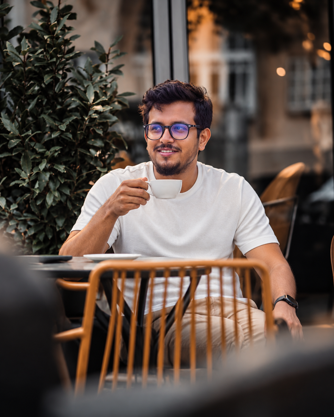 Mehedi Hasan Nakib smiling, holding a cup of coffee